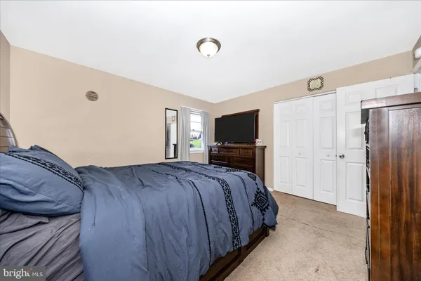 a bed room with a bed and a television