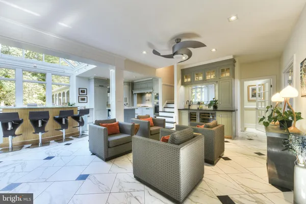 a living room with furniture and a floor to ceiling window