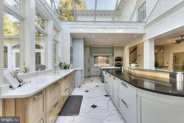 a spacious bathroom with a double vanity sink a mirror a bathtub and a shower