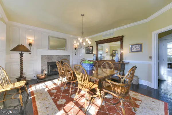 a living room with furniture a chandelier and a dining table