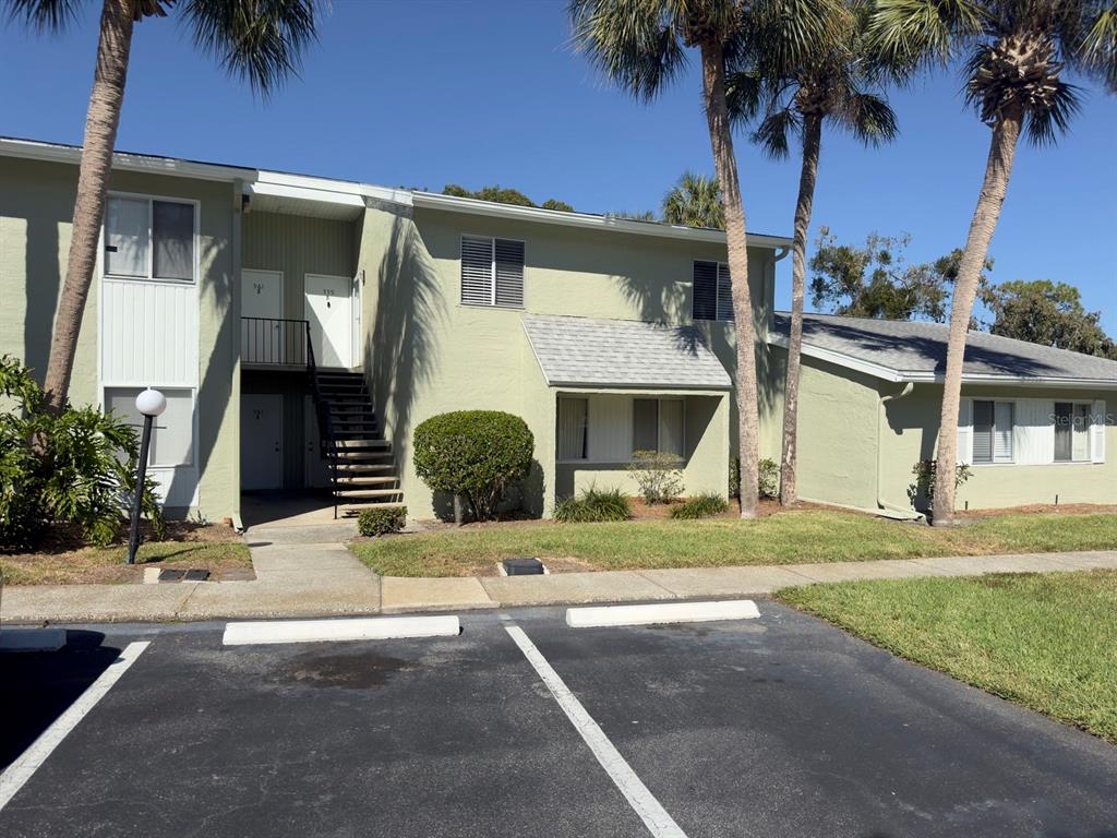 a front view of a house with garden and patio