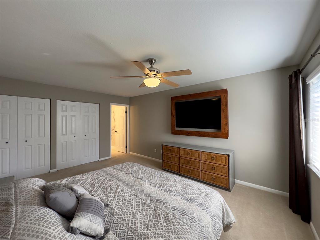 559 Fairways Circle Ocala, FL 34472 - Photo 13 of 29 a bedroom with a bed and a flat screen tv