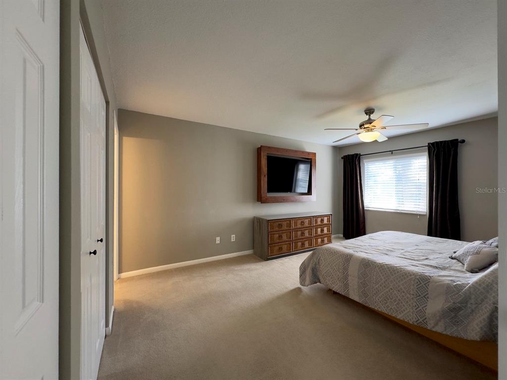 559 Fairways Circle Ocala, FL 34472 - Photo 16 of 29 a spacious bedroom with a bed and a flat screen tv