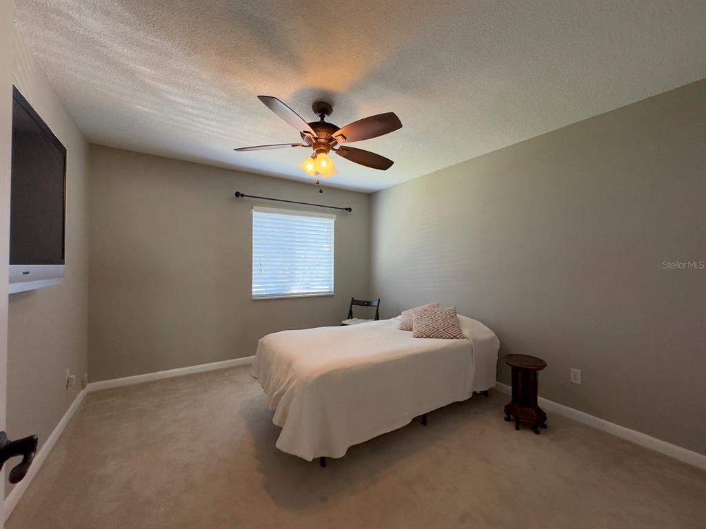 559 Fairways Circle Ocala, FL 34472 - Photo 20 of 29 a bedroom with a bed and a ceiling fan