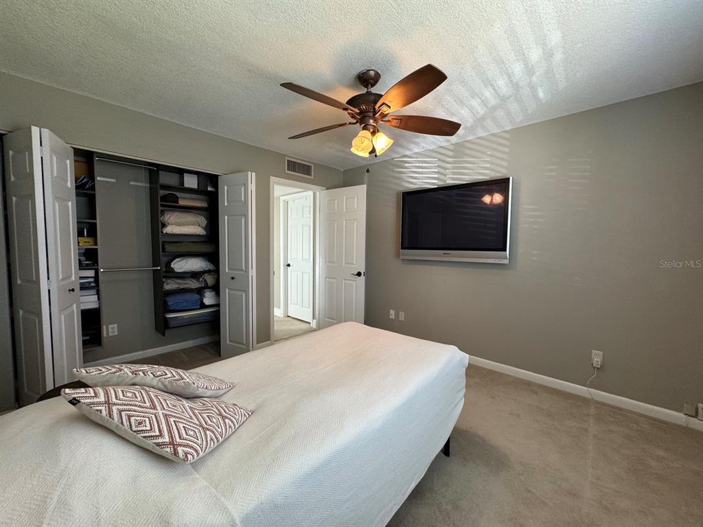559 Fairways Circle Ocala, FL 34472 - Photo 23 of 29 a bedroom with a bed and a chandelier