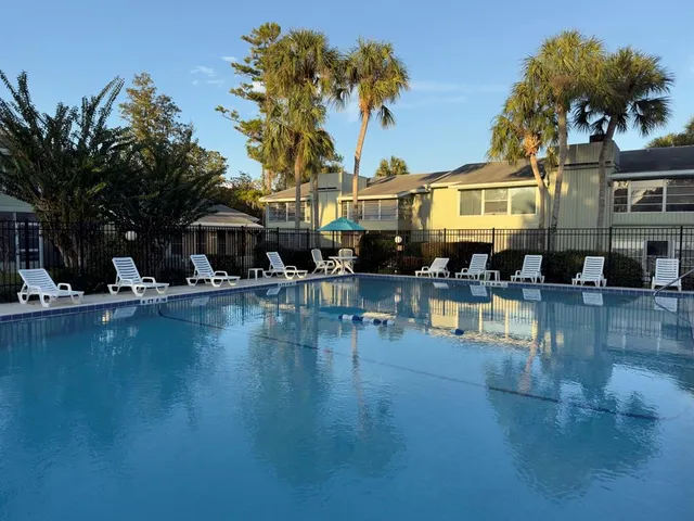a swimming pool view with a outdoor seating