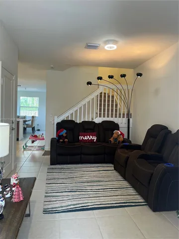 a living room with furniture and a lamp