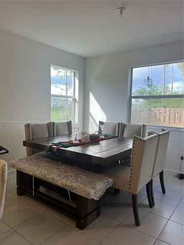 a view of a dining room with furniture window and outside view
