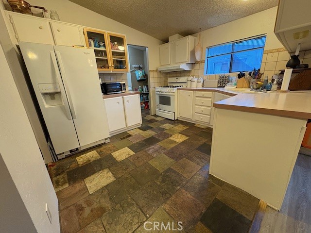 100 Ski Trails Road, Unit 42 Mammoth Lakes, CA 93546 - Photo 4 of 15 a kitchen with stainless steel appliances a stove a sink and a refrigerator