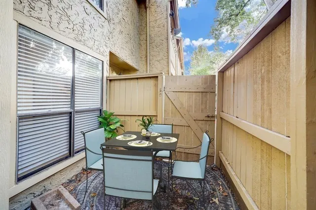 a backyard of a house with table and chairs