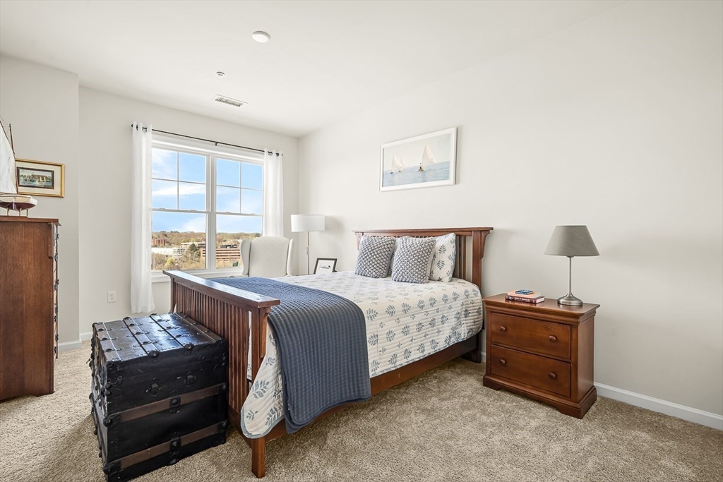 2 Stratton Drive, Unit 307 Woburn, MA 01801 - Photo 13 of 21 a bedroom with a bed and a window