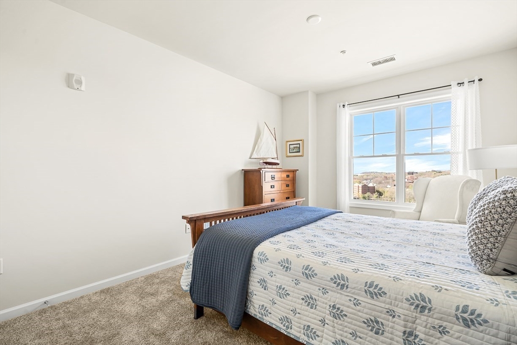2 Stratton Drive, Unit 307 Woburn, MA 01801 - Photo 14 of 21 a bedroom with a bed and window