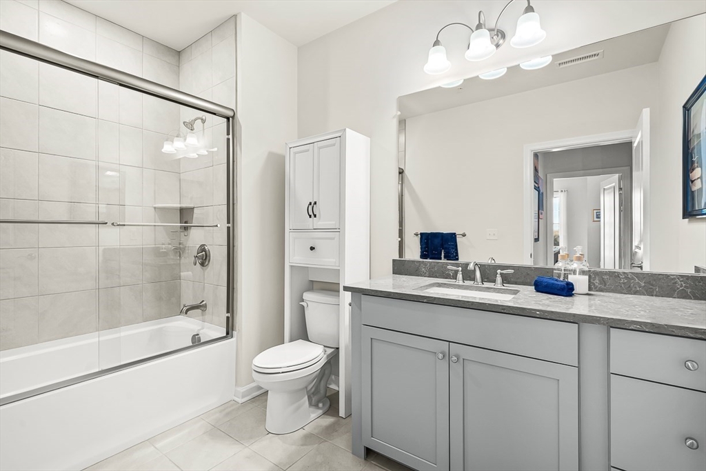 2 Stratton Drive, Unit 307 Woburn, MA 01801 - Photo 15 of 21 a bathroom with a sink a toilet and shower