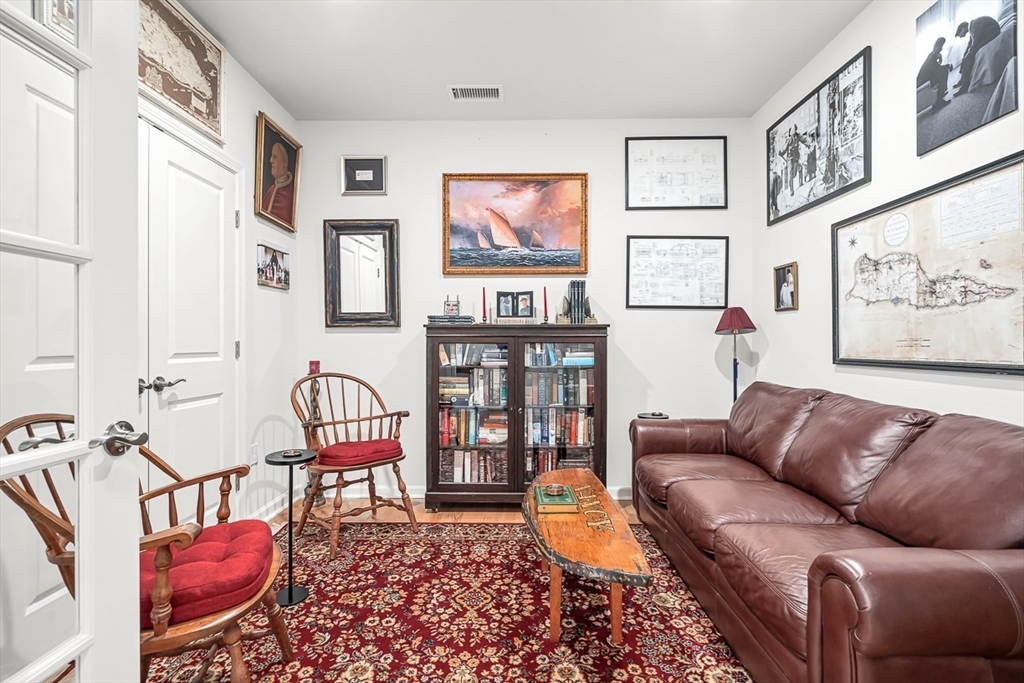 2 Stratton Drive, Unit 307 Woburn, MA 01801 - Photo 16 of 21 a living room with furniture a rug and a wall painting