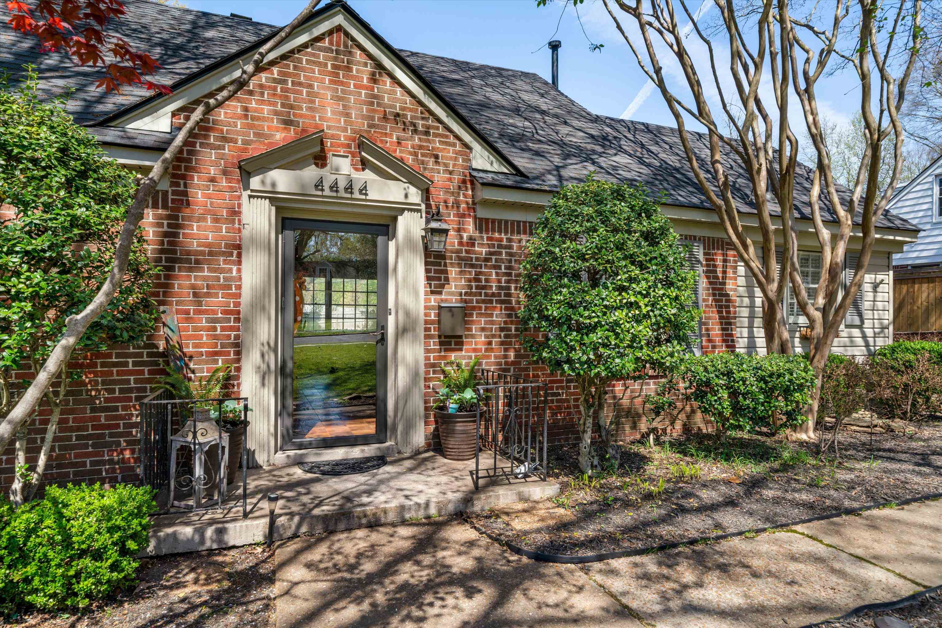 4444 Sequoia Road Memphis, TN 38117 - Photo 3 of 25 a view of a brick house with plants and large tree