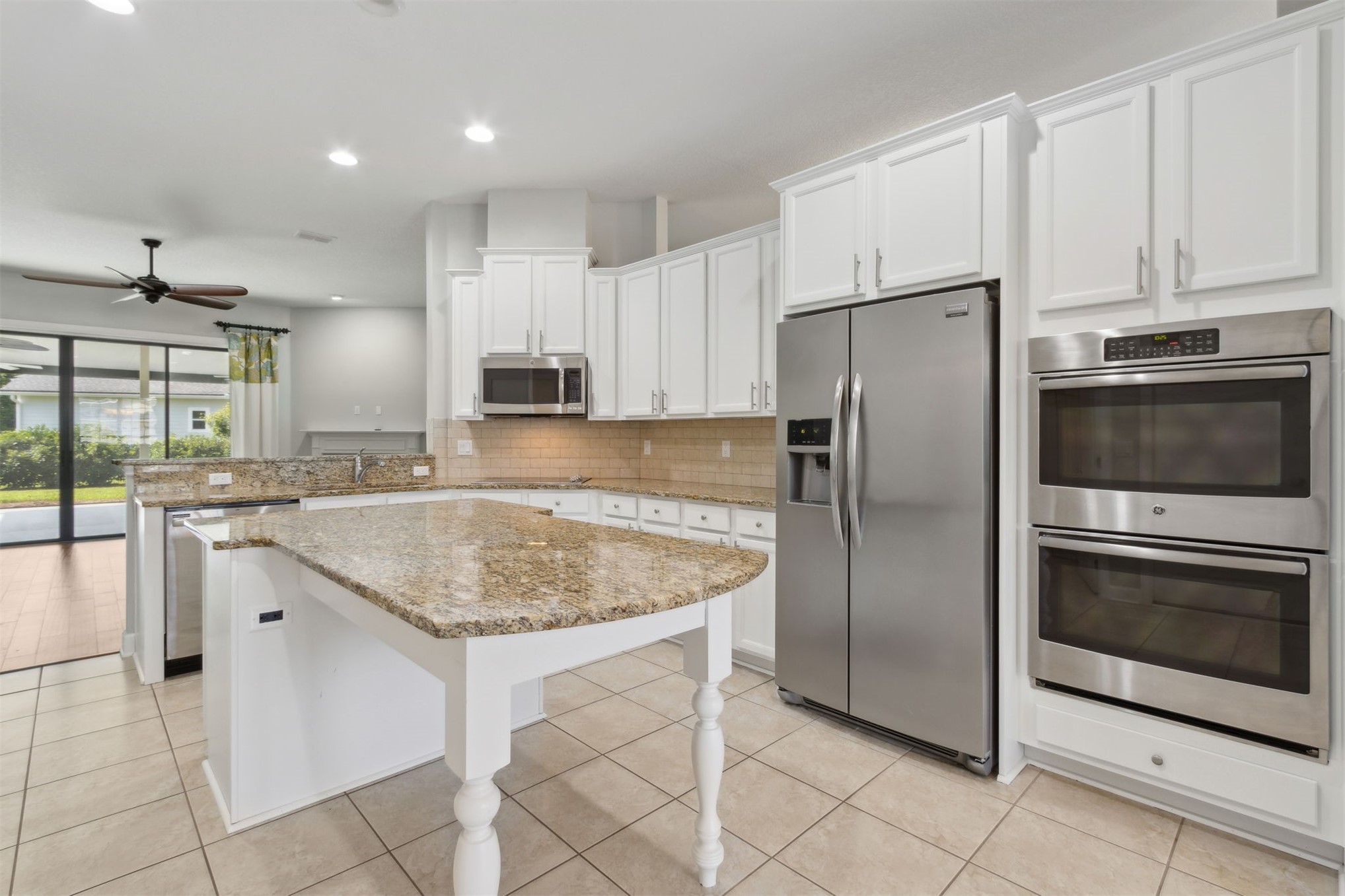 33146 Prairie Parke Place Fernandina Beach, FL 32034 - Photo 4 of 28 a kitchen with stainless steel appliances granite countertop a sink stove and refrigerator