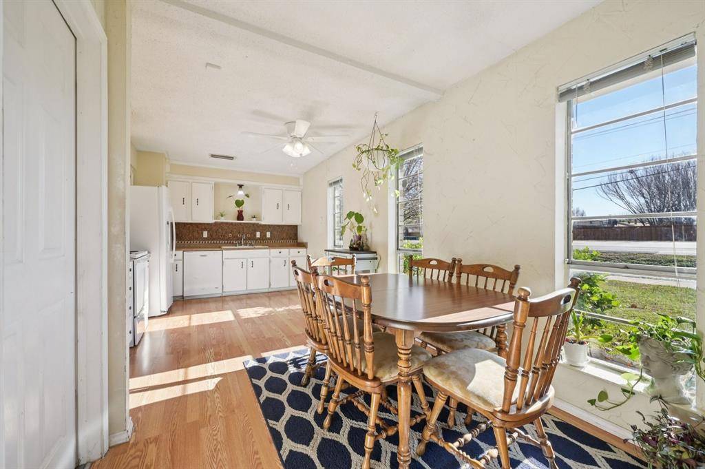 1021 Pleasant Valley Road Garland, TX 75040 - Photo 11 of 32 a dining room with furniture and a floor to ceiling window