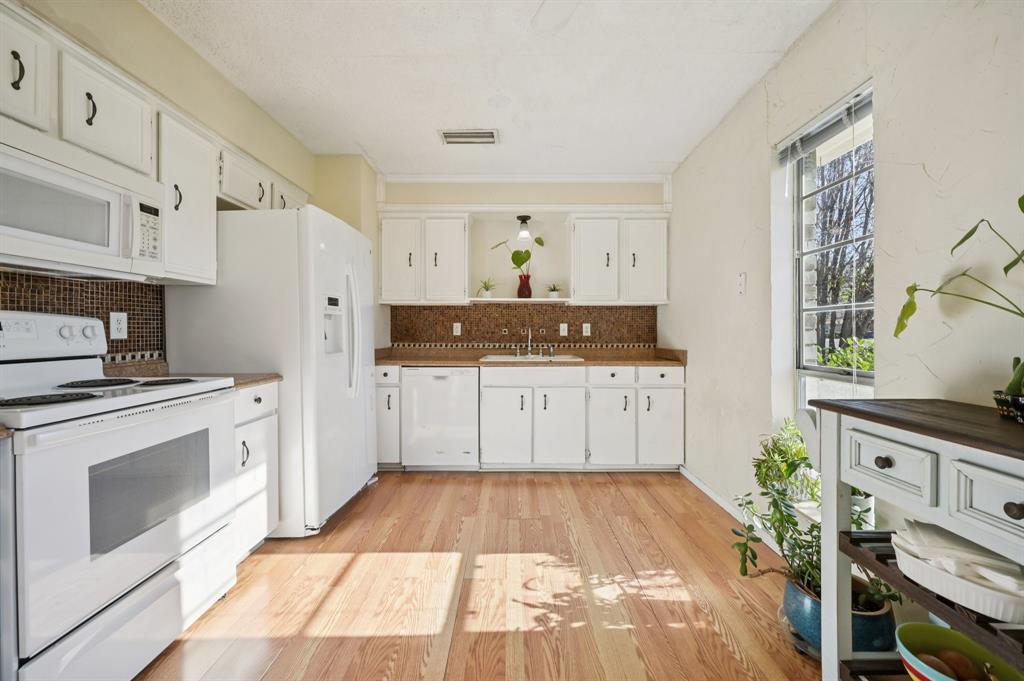 1021 Pleasant Valley Road Garland, TX 75040 - Photo 14 of 32 a kitchen with stainless steel appliances a stove a sink and a refrigerator