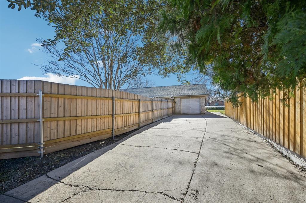 1021 Pleasant Valley Road Garland, TX 75040 - Photo 31 of 32 a view of house with backyard and trees