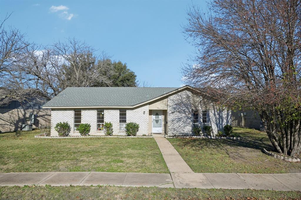 1021 Pleasant Valley Road Garland, TX 75040 - Photo 4 of 32 a front view of a house with a yard