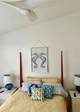 a bedroom with a bed and a painting on the wall