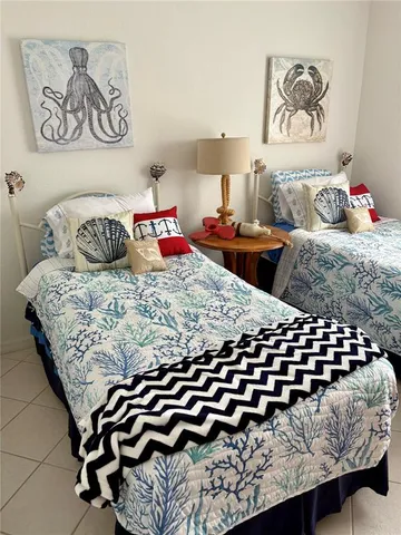 a bedroom with a bed and painting on the wall