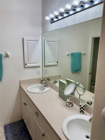 a bathroom with a double vanity sink and a mirror
