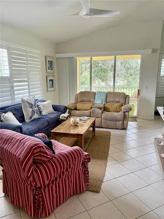 a living room with furniture and large windows