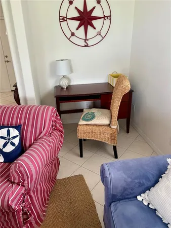 a living room with furniture and a mirror