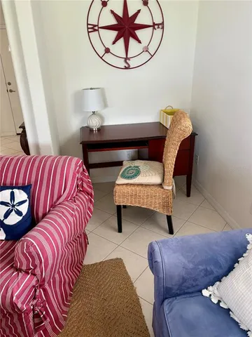 a living room with furniture and a mirror