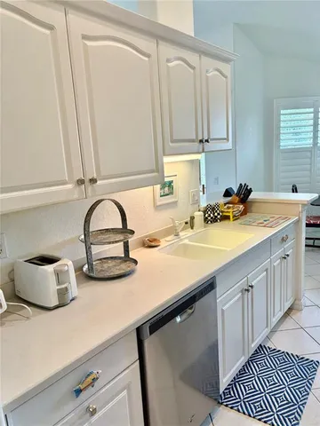 a kitchen with a sink cabinets and wooden floor