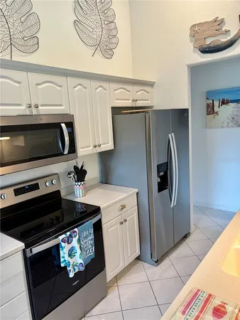 a kitchen with stainless steel appliances a stove a microwave and cabinets