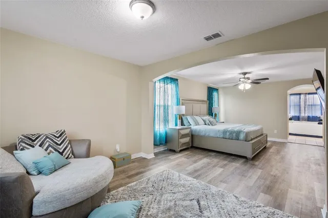 a bedroom with furniture and wooden floor