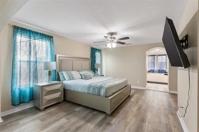 a living room with a bed furniture and a flat tv screen