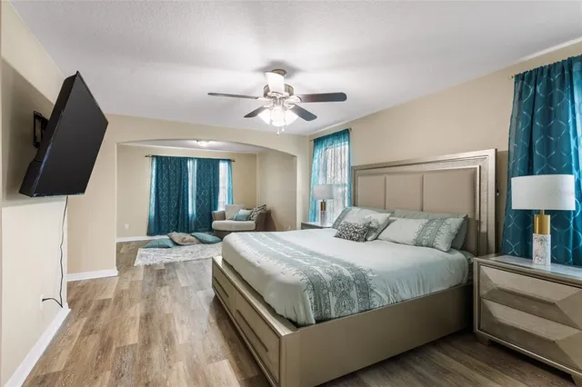 a bedroom with a bed and a flat screen tv