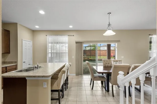 a view of a dining room with furniture wooden floor and chandelier