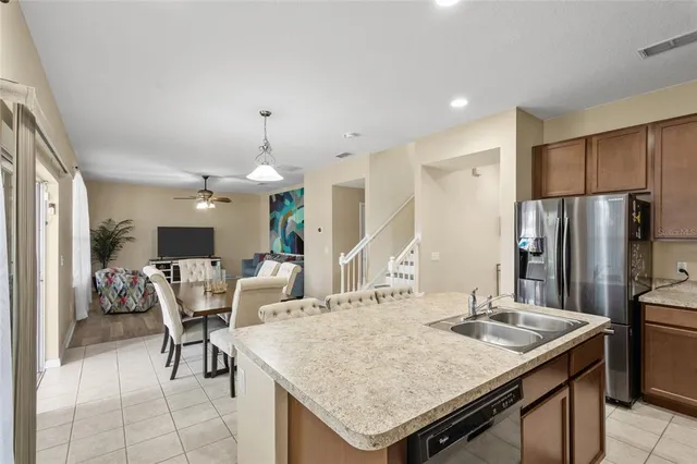 a kitchen with a table chairs and refrigerator