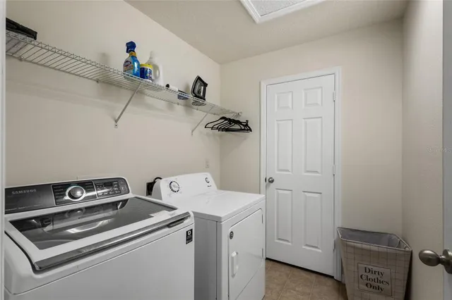 a view of storage and utility room with washer and dryer
