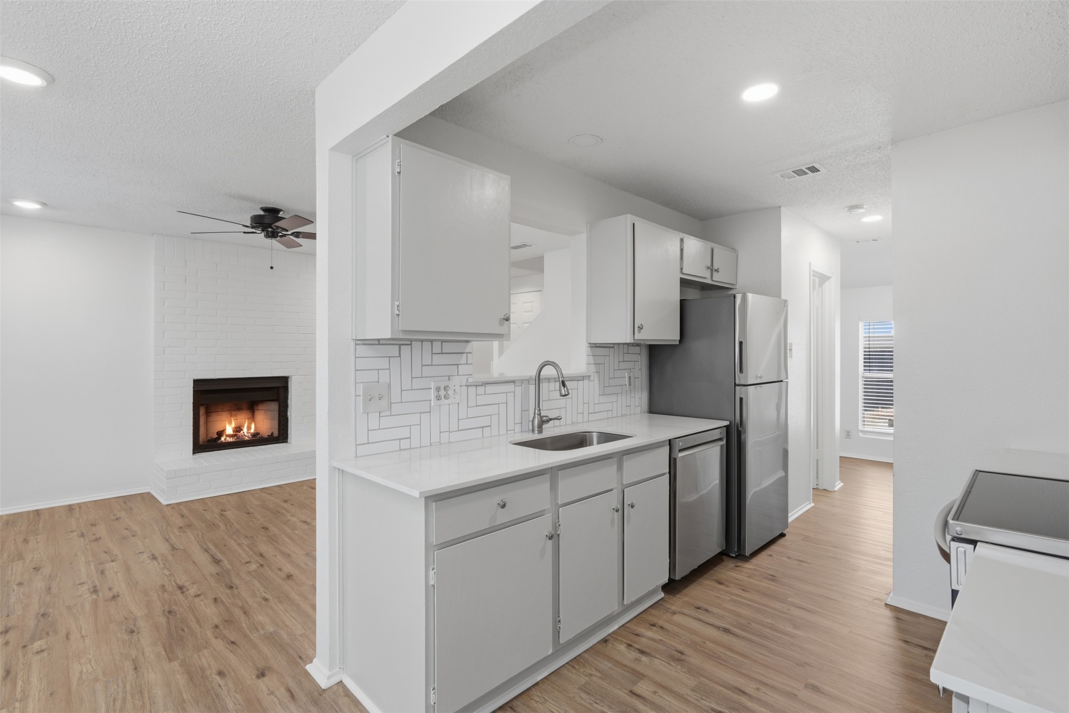 6105 Conti Court, Unit A Austin, TX 78744 - Photo 11 of 36 a kitchen with a sink stove and refrigerator