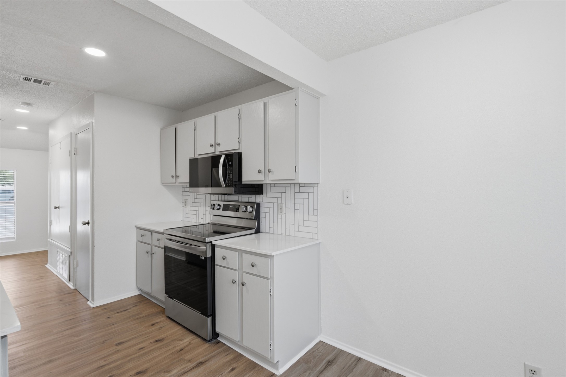 6105 Conti Court, Unit A Austin, TX 78744 - Photo 14 of 36 a kitchen with stainless steel appliances granite countertop a stove a sink and a refrigerator