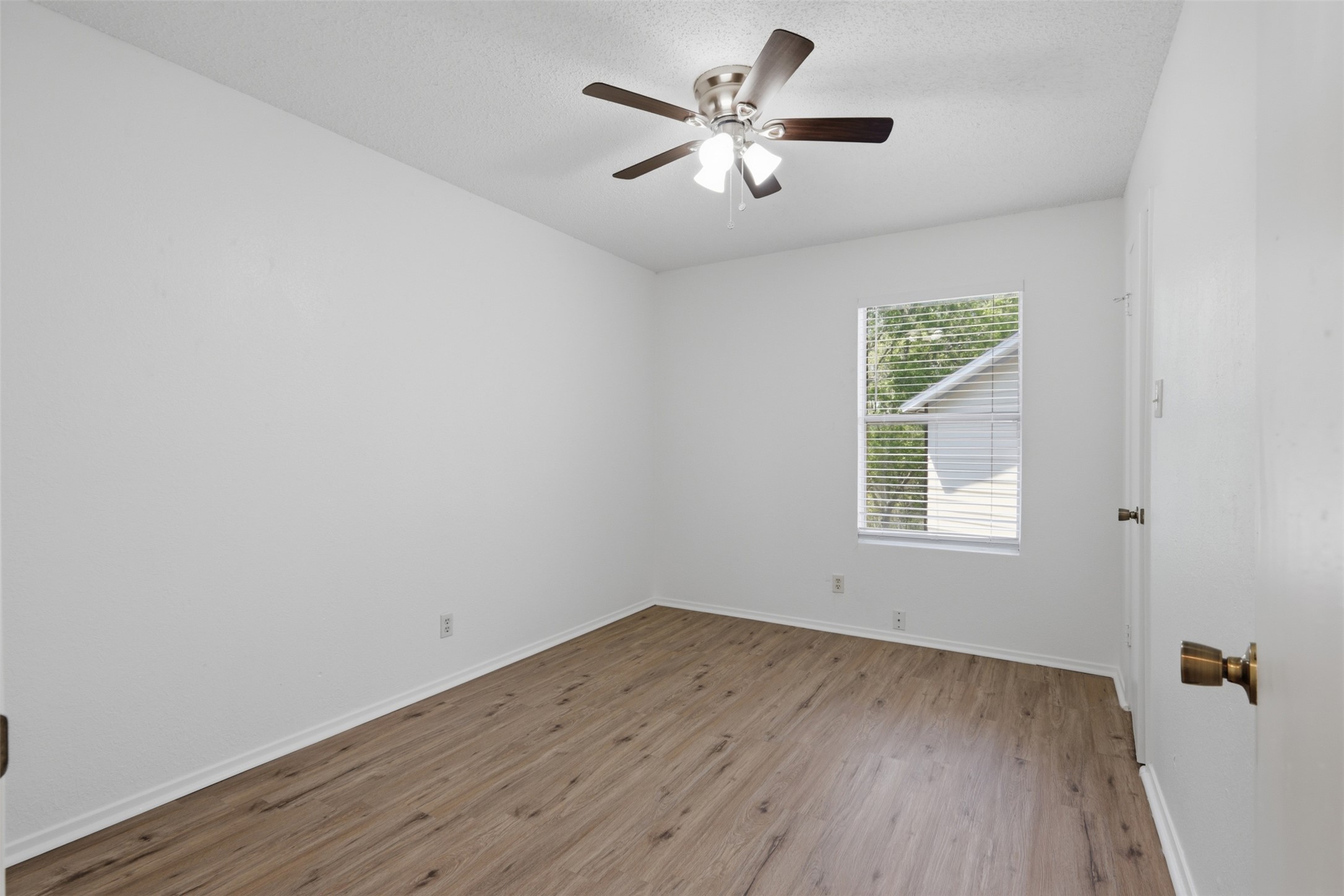 6105 Conti Court, Unit A Austin, TX 78744 - Photo 18 of 36 wooden floor in an empty room with a window