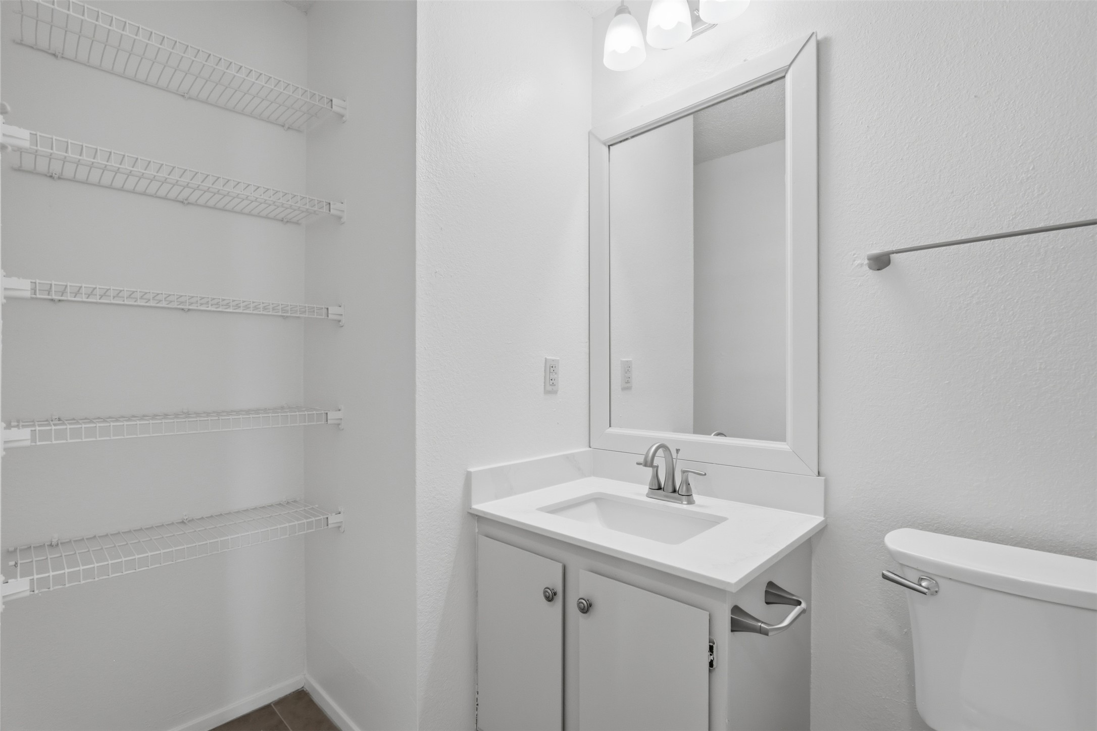 6105 Conti Court, Unit A Austin, TX 78744 - Photo 19 of 36 a bathroom with a sink toilet and mirror