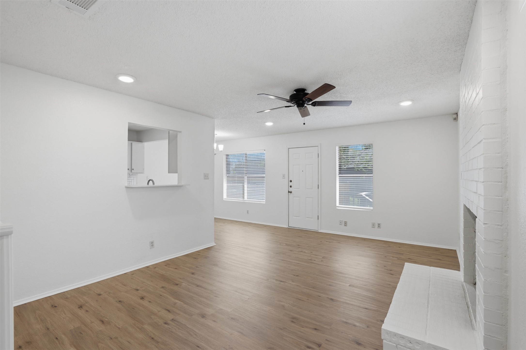 6105 Conti Court, Unit A Austin, TX 78744 - Photo 6 of 36 wooden floor in an empty room with a window