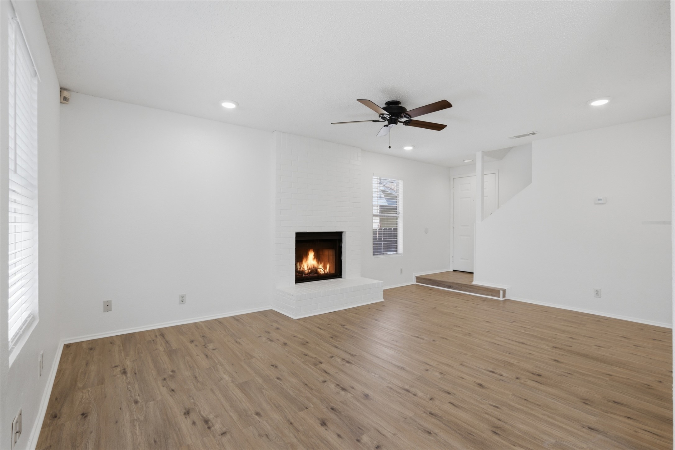 6105 Conti Court, Unit A Austin, TX 78744 - Photo 7 of 36 wooden floor in an empty room with a fireplace