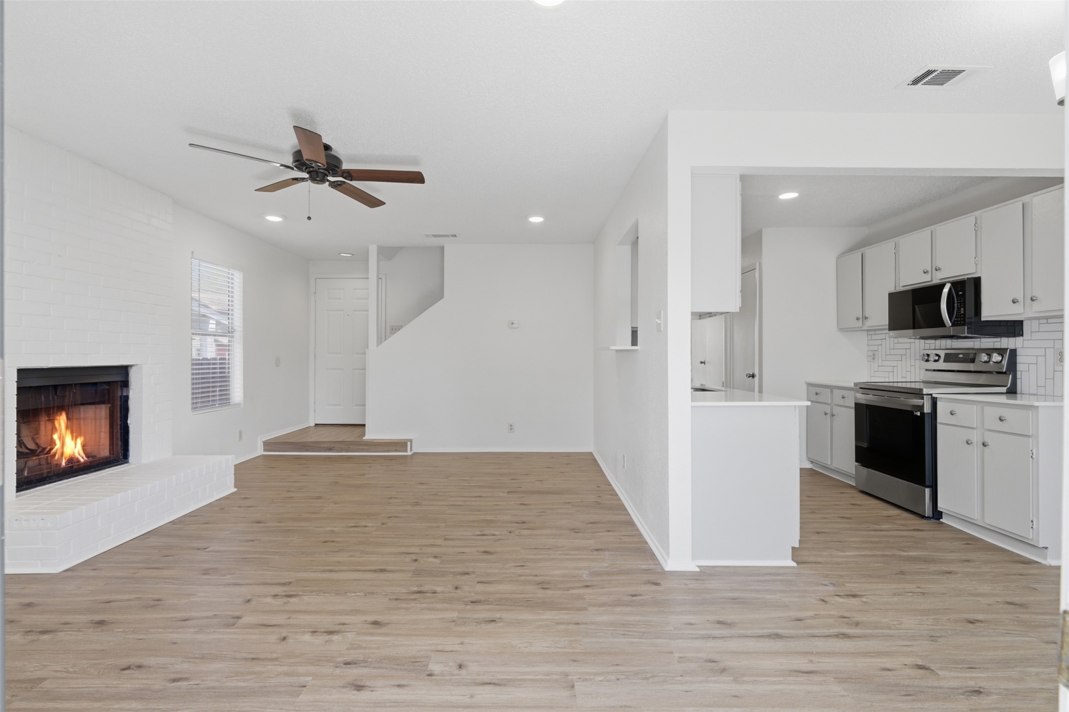 6105 Conti Court, Unit A Austin, TX 78744 - Photo 36 of 36 a view of a kitchen with a sink and a fireplace