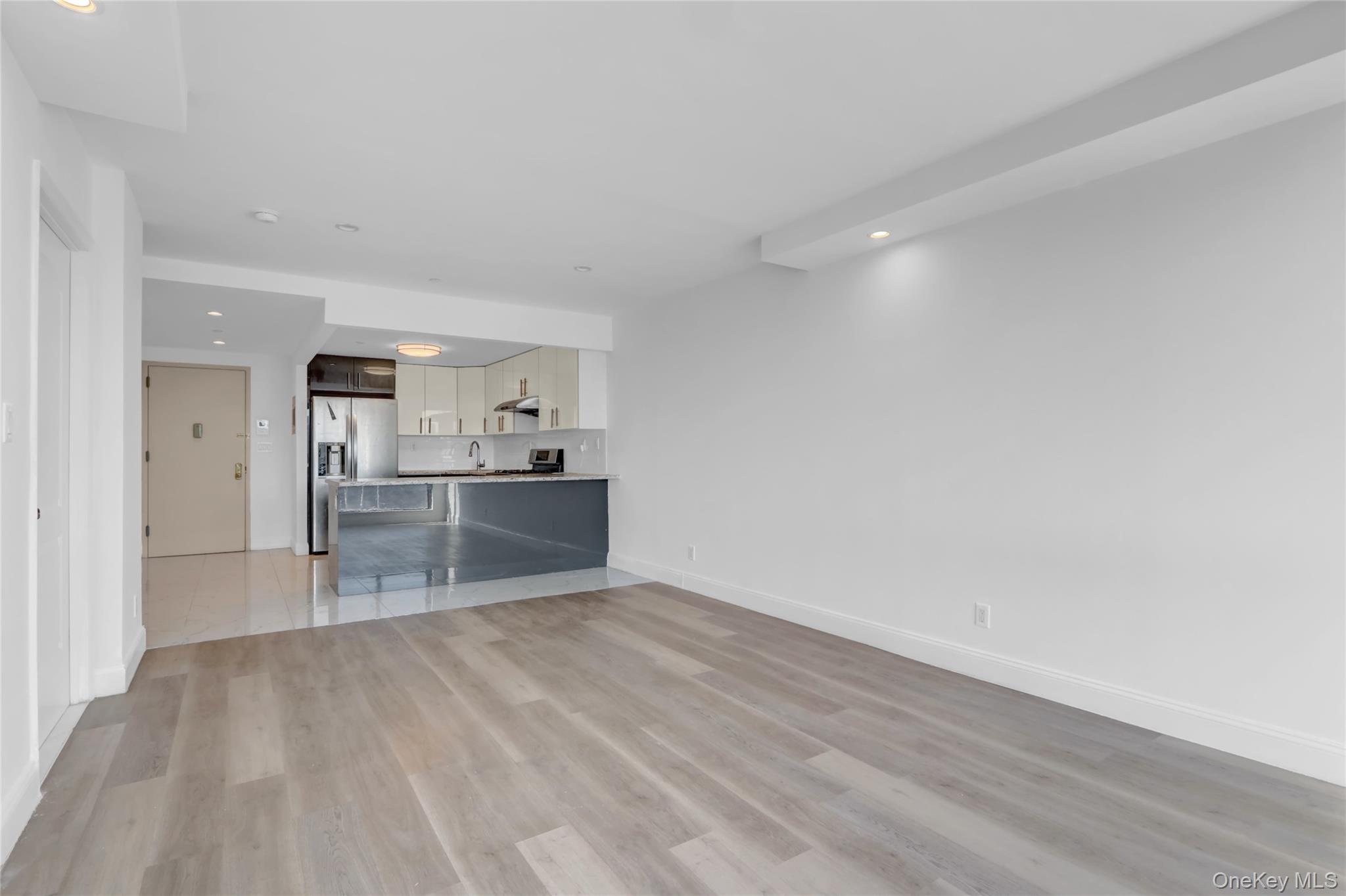 45-16 83rd Street, Unit W7C Queens, NY 11373 - Photo 11 of 16 a view of a kitchen with wooden floor