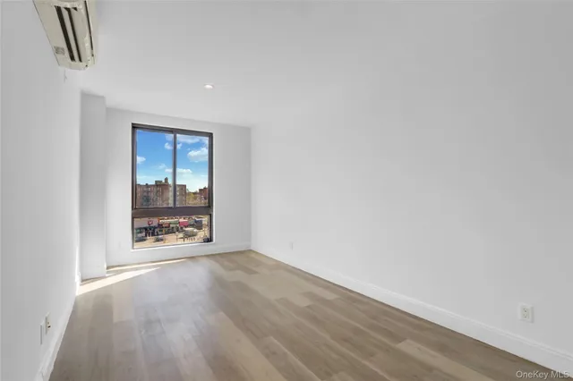 a view of an empty room and wooden floor