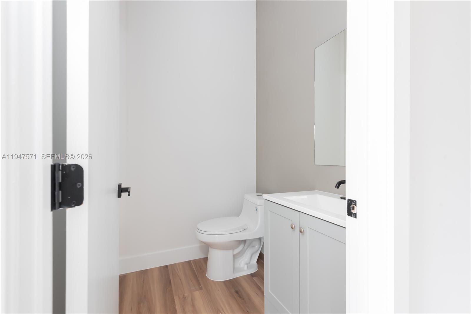 4517 Northwest 3rd Street Miami, FL 33126 - Photo 14 of 34 a white toilet sitting next to a bathroom sink