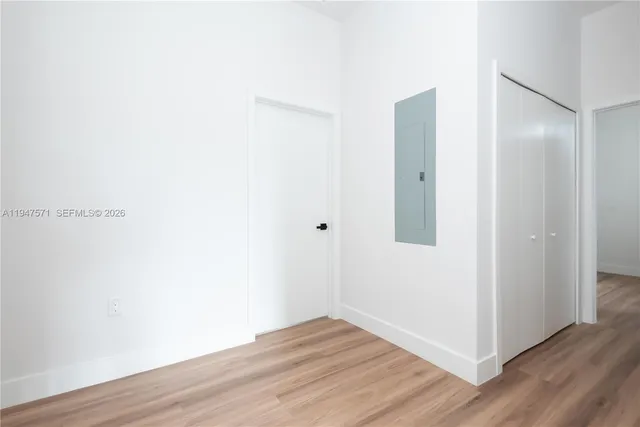 a view of an empty room with wooden floor