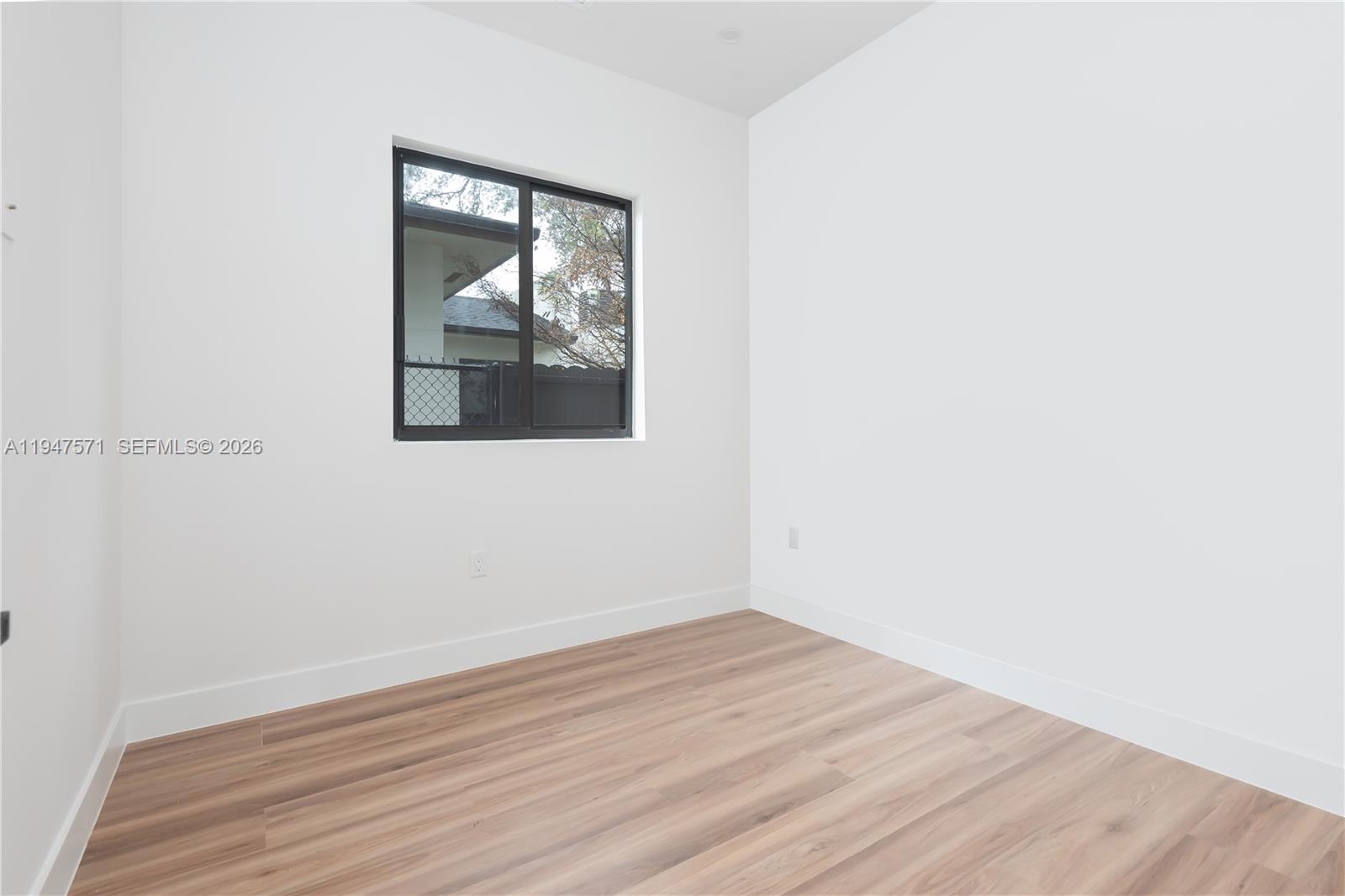 4517 Northwest 3rd Street Miami, FL 33126 - Photo 17 of 34 a view of a small space with wooden floor and a window